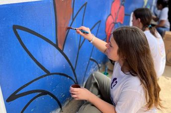 Painting a mural in Panama on Good Deeds Day.