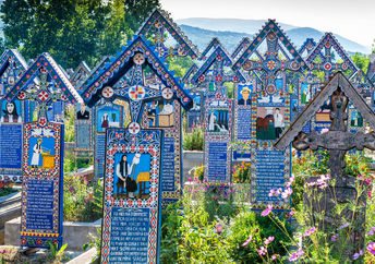 Painted wooden crosses in the famous Merry Cemetery in Maramures, Romania. (Danilovski / Shutterstock.com)