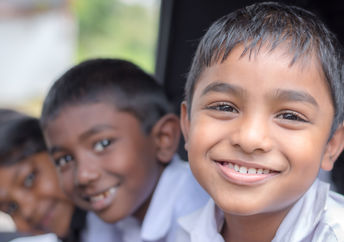 Happy, healthy Indian children smiling as they go to school.