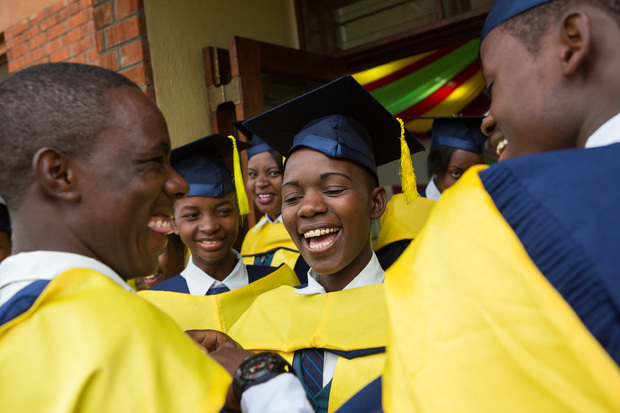Form 6 students gleefully prepare for their School of St Jude graduation ceremony.