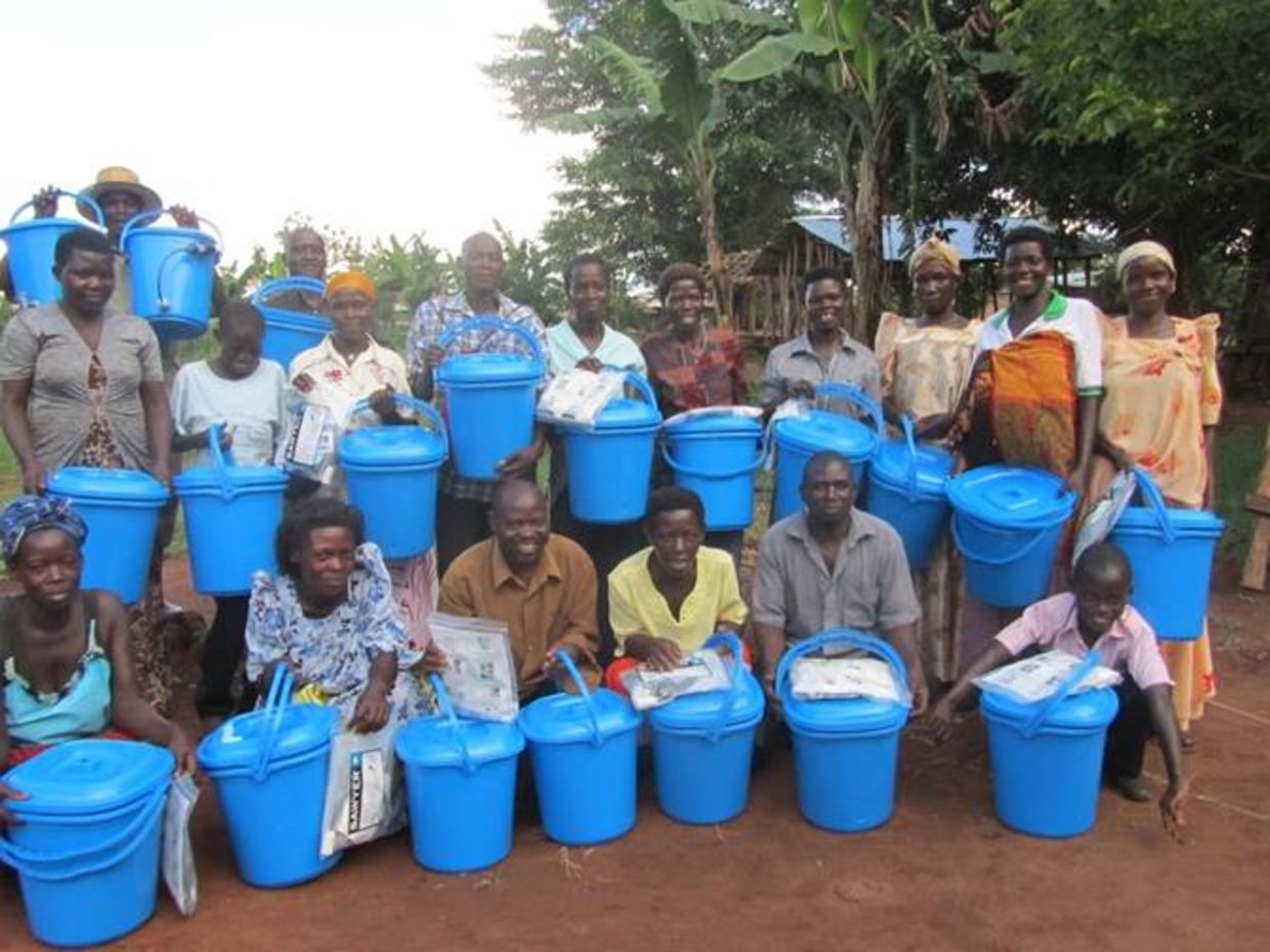 Ugandans holding water filtration packets