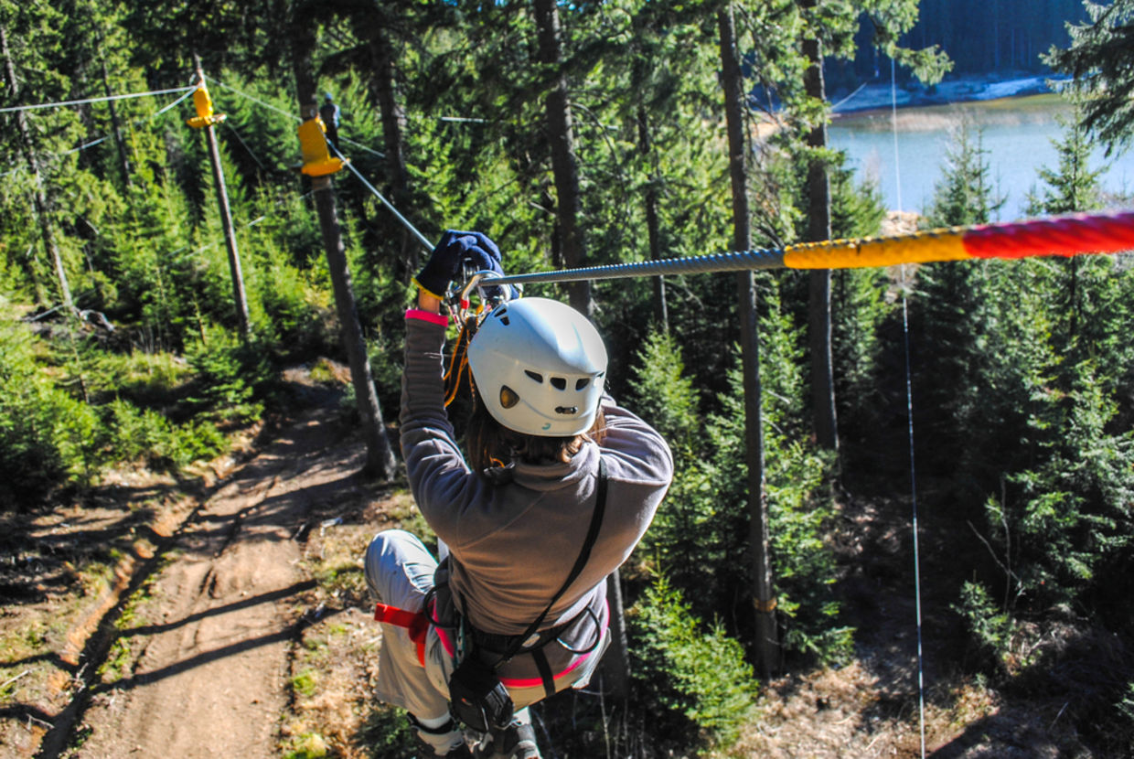 Woman sliding on a zip line in an adventure park (Shutterstock)