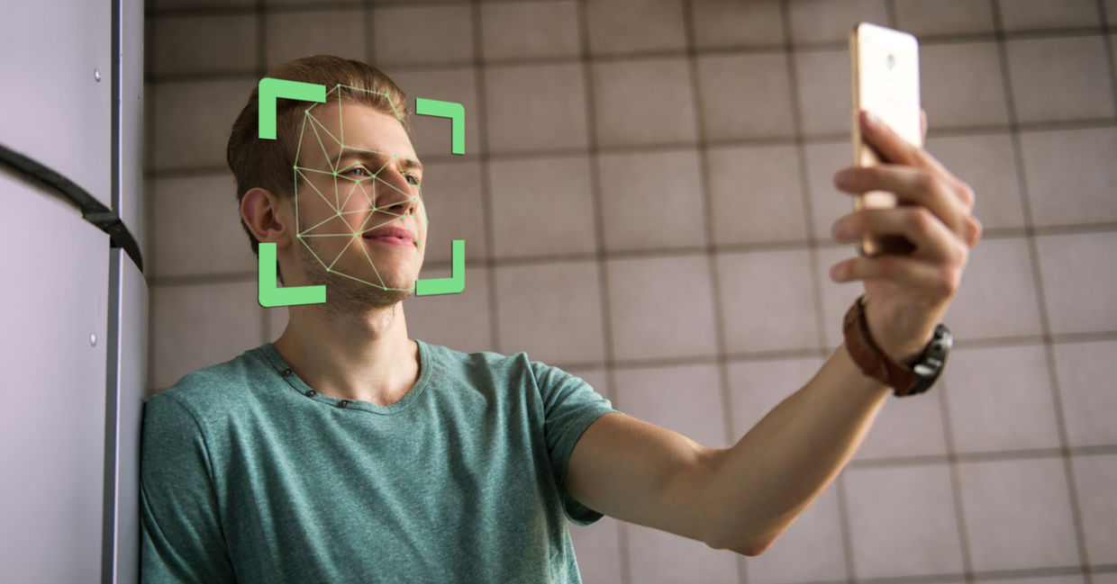 Man scanning face with smartphone
