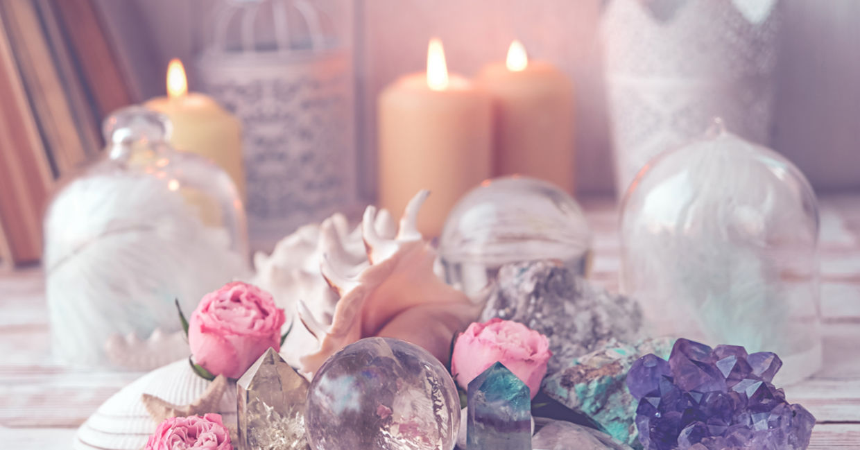 Flickering candles alongside crystals and healing stones are used to manifest dreams.