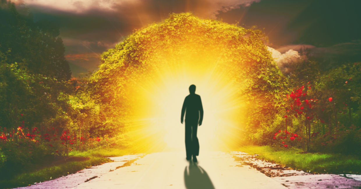 A person walks down a road into light, reflecting the spiritual love a lightworker shines.