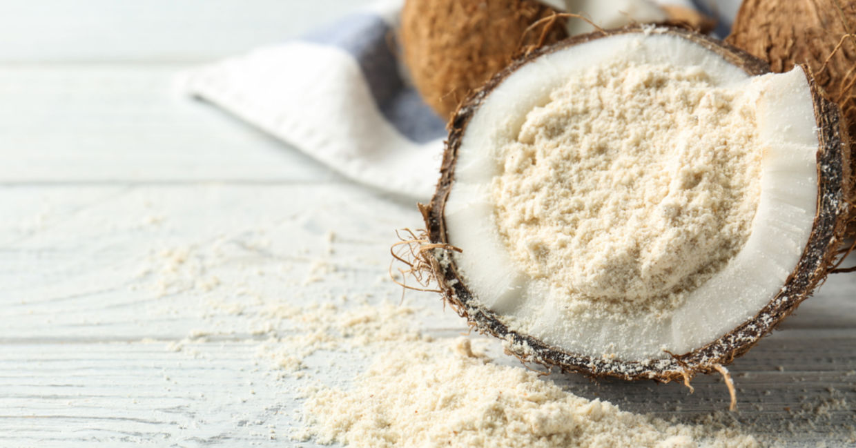 Healthy, gluten-free coconut flour placed in a coconut husk.
