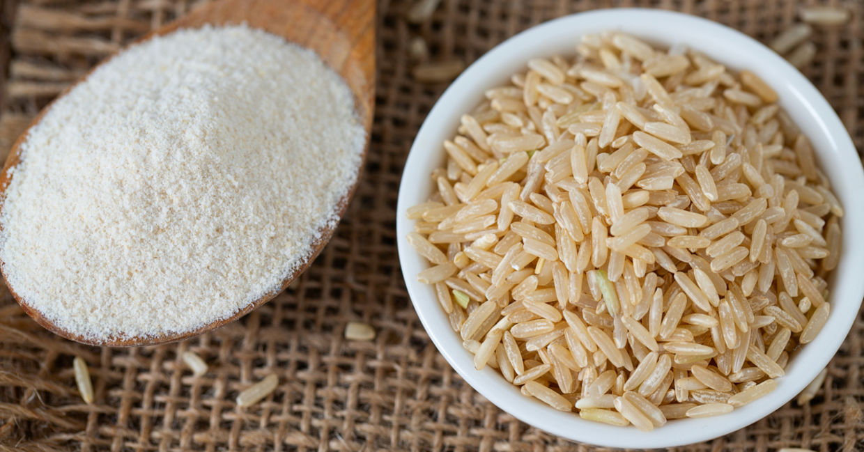 A spoonful of gluten free brown rice flour rice set beside a bowl of brown rice.