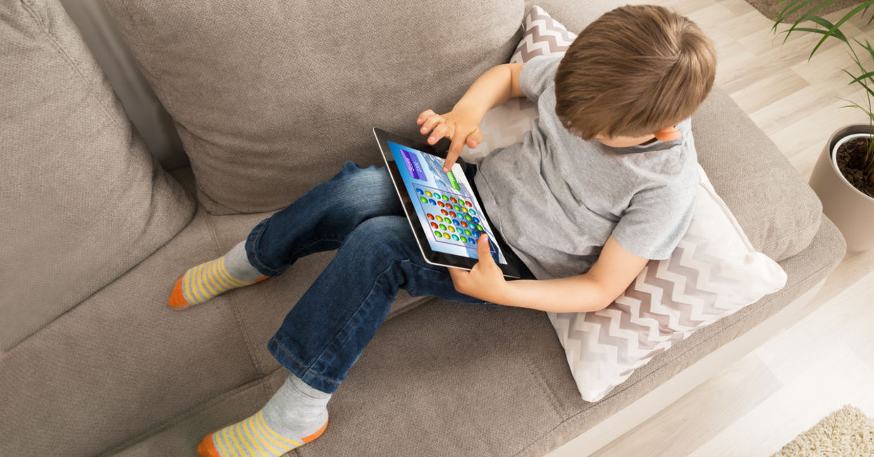 kid using an app on a tablet.