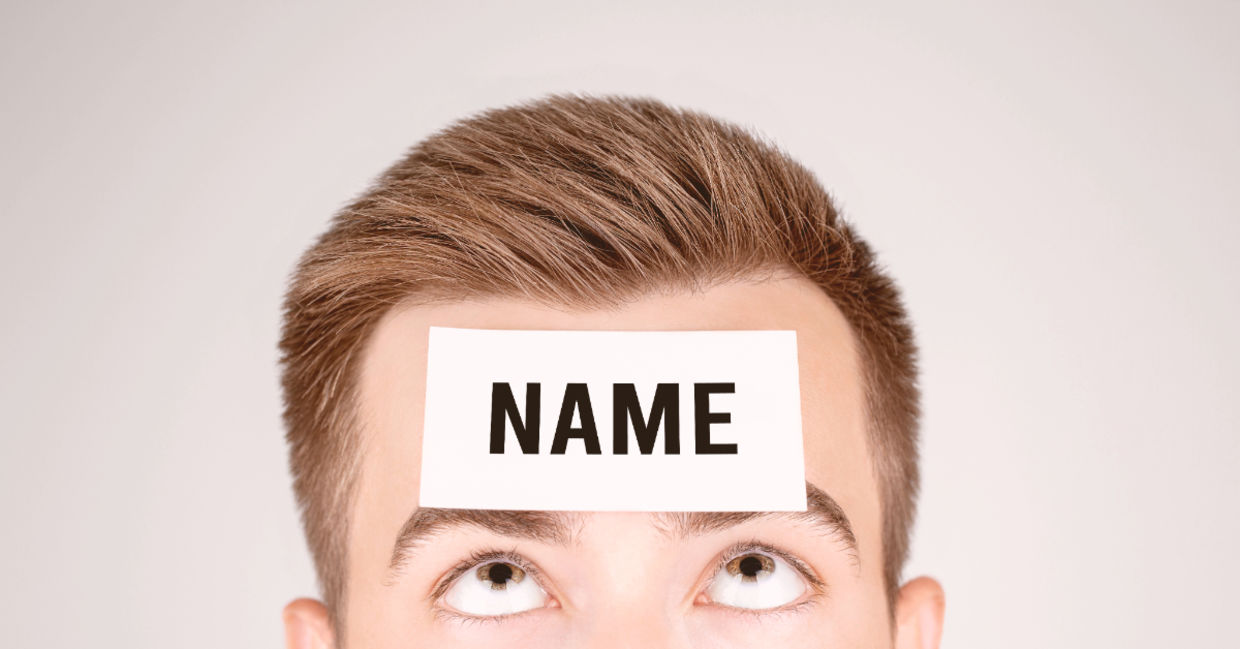 Man looking at paper with Name pasted on his forehead.