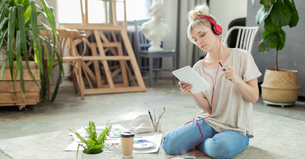 Creative woman listening to music while working.