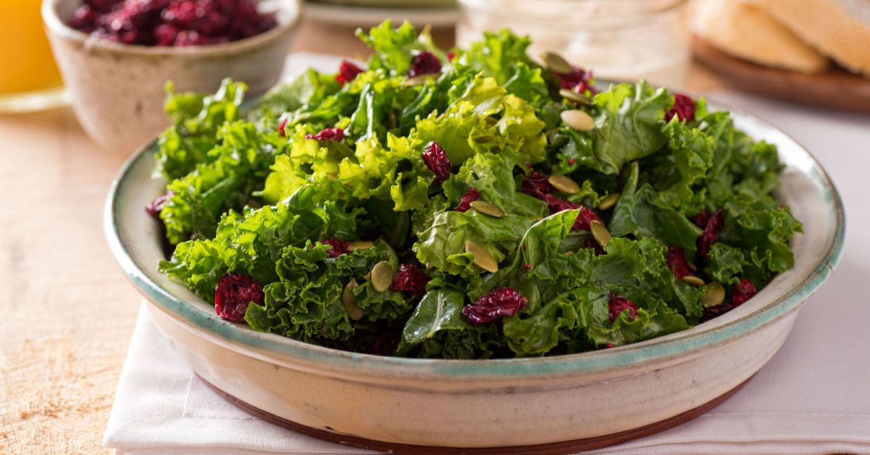 A kale, cranberry, and pumpkin seed salad is a healthy lunch choice.