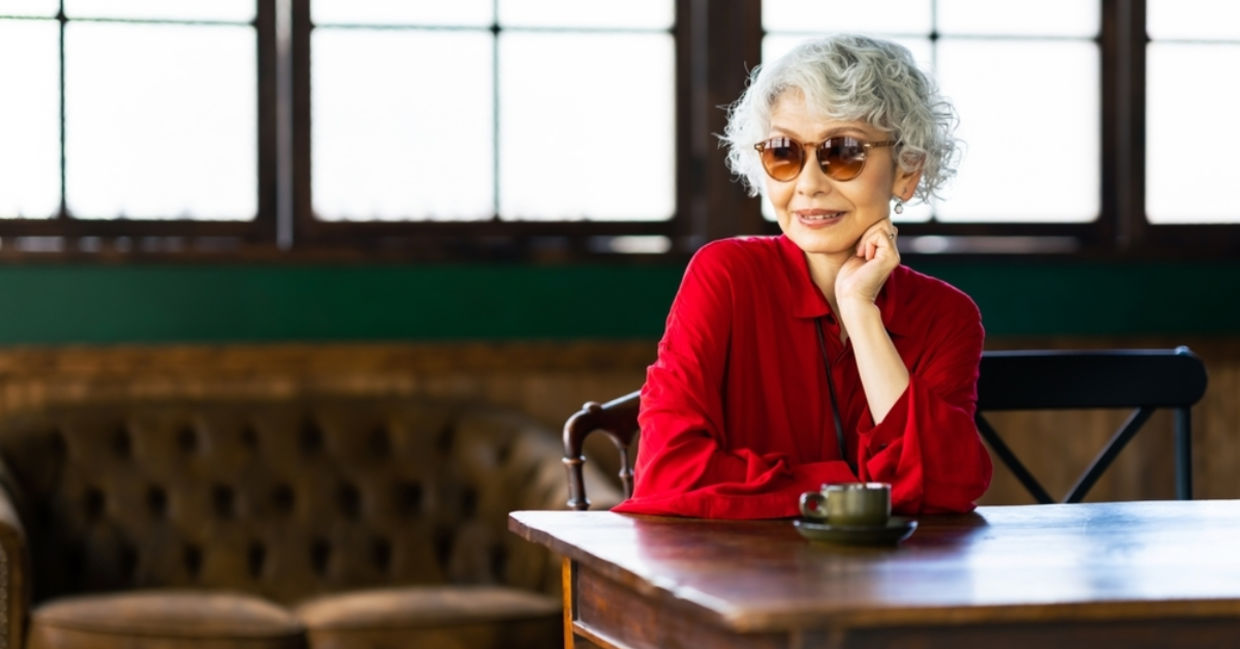 Senior Japanese woman relaxing in a restaurant.