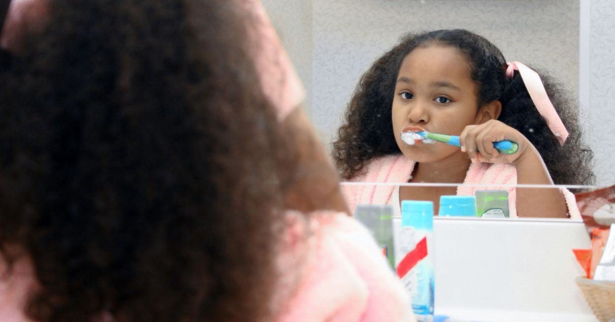 Little girl brushing her teeth.