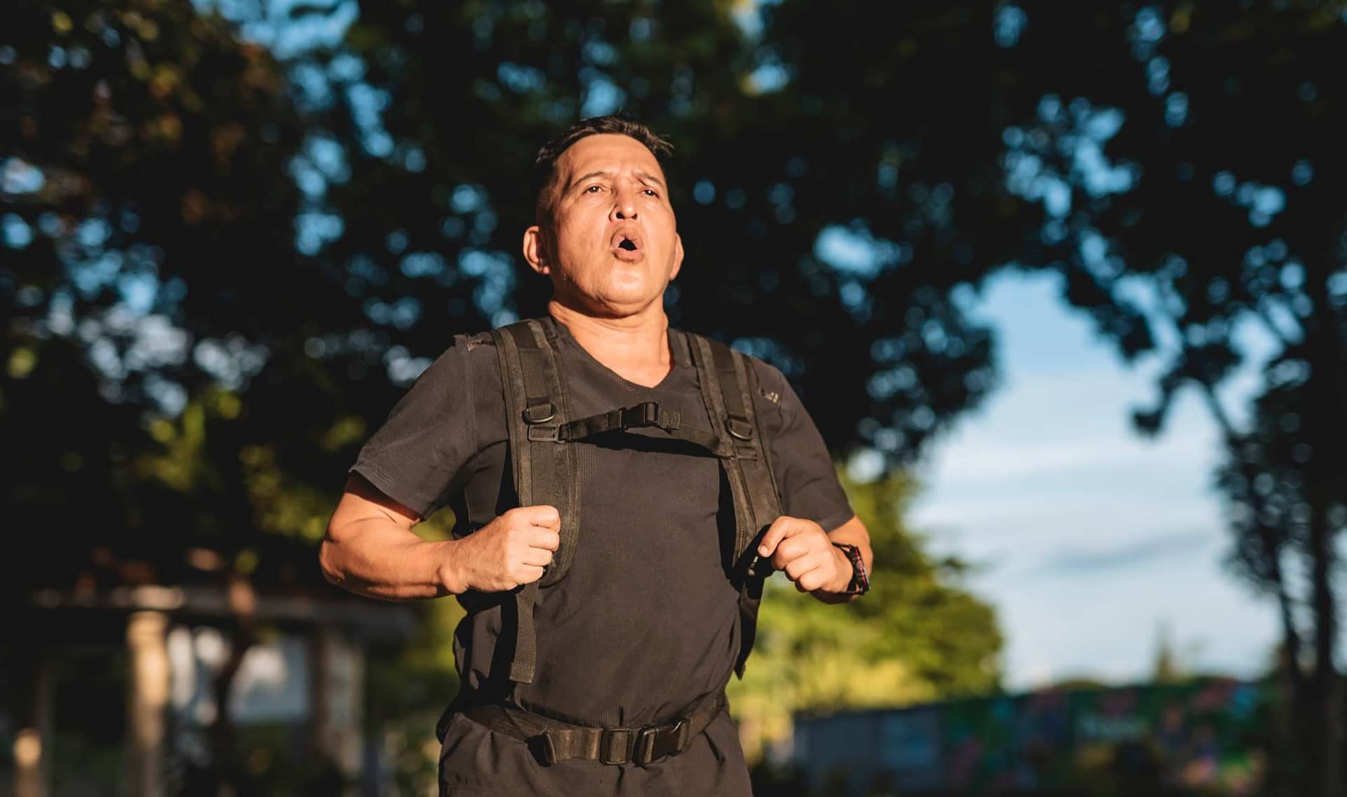 Man wearing a weighted vest.
