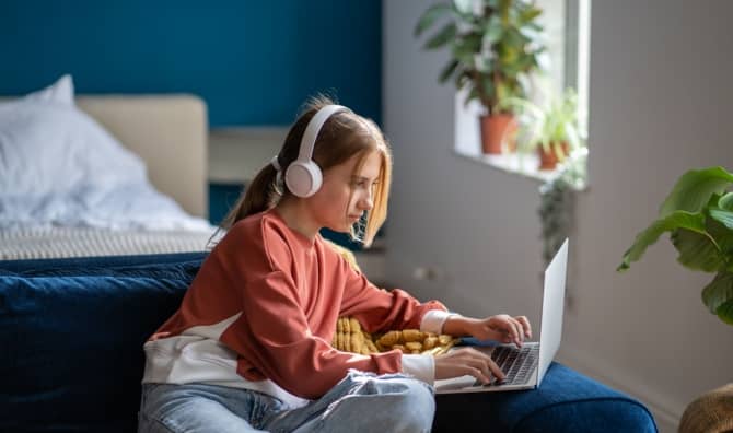 A teen focused on an online lesson.