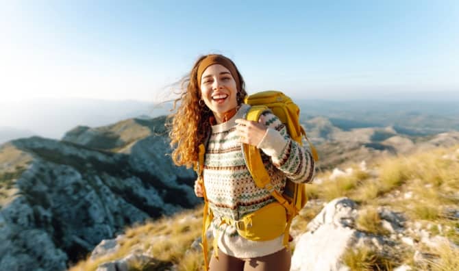 Woman backpacking on a hiking trail.