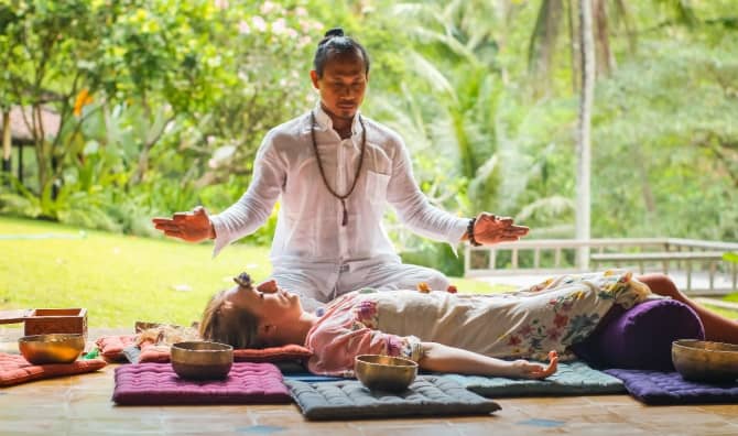 A high priest does chakra healing in Bali.