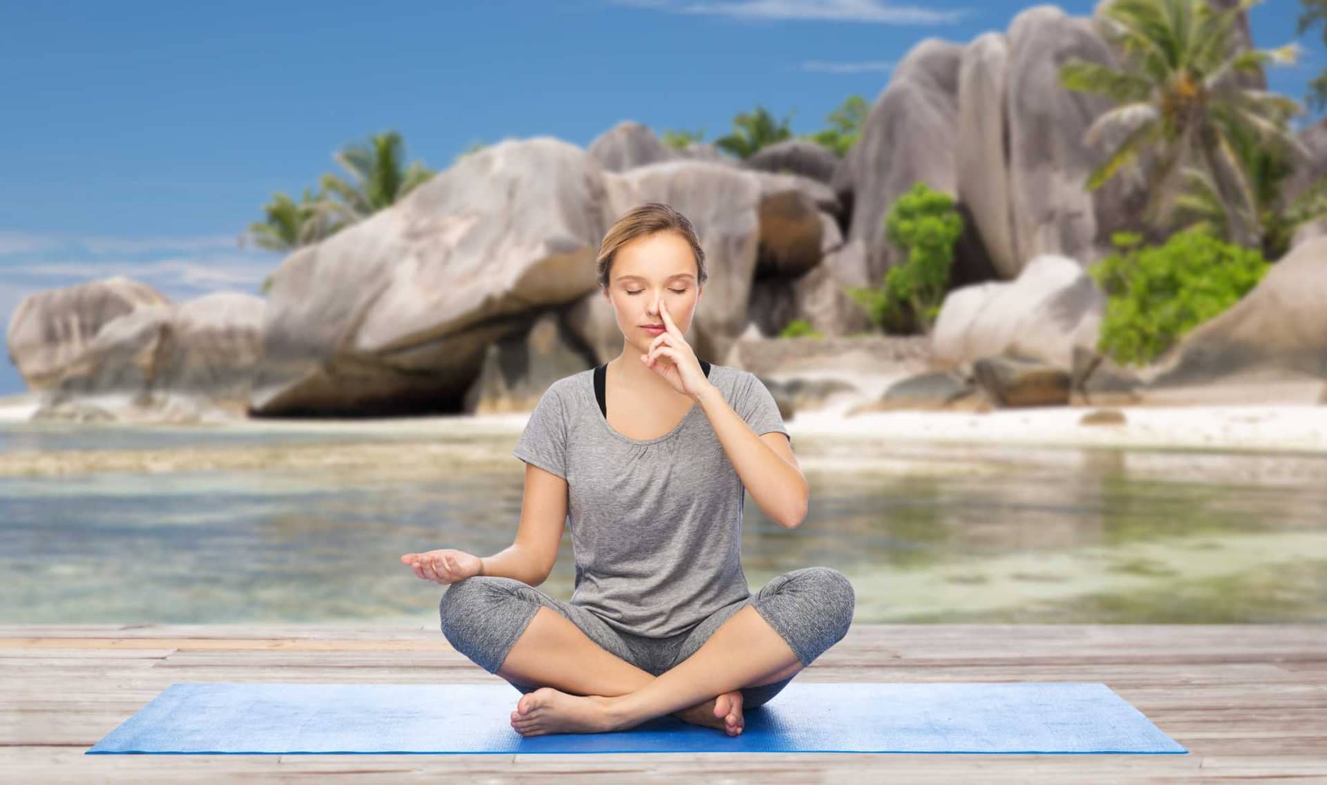Woman doing breathwork on the beach.