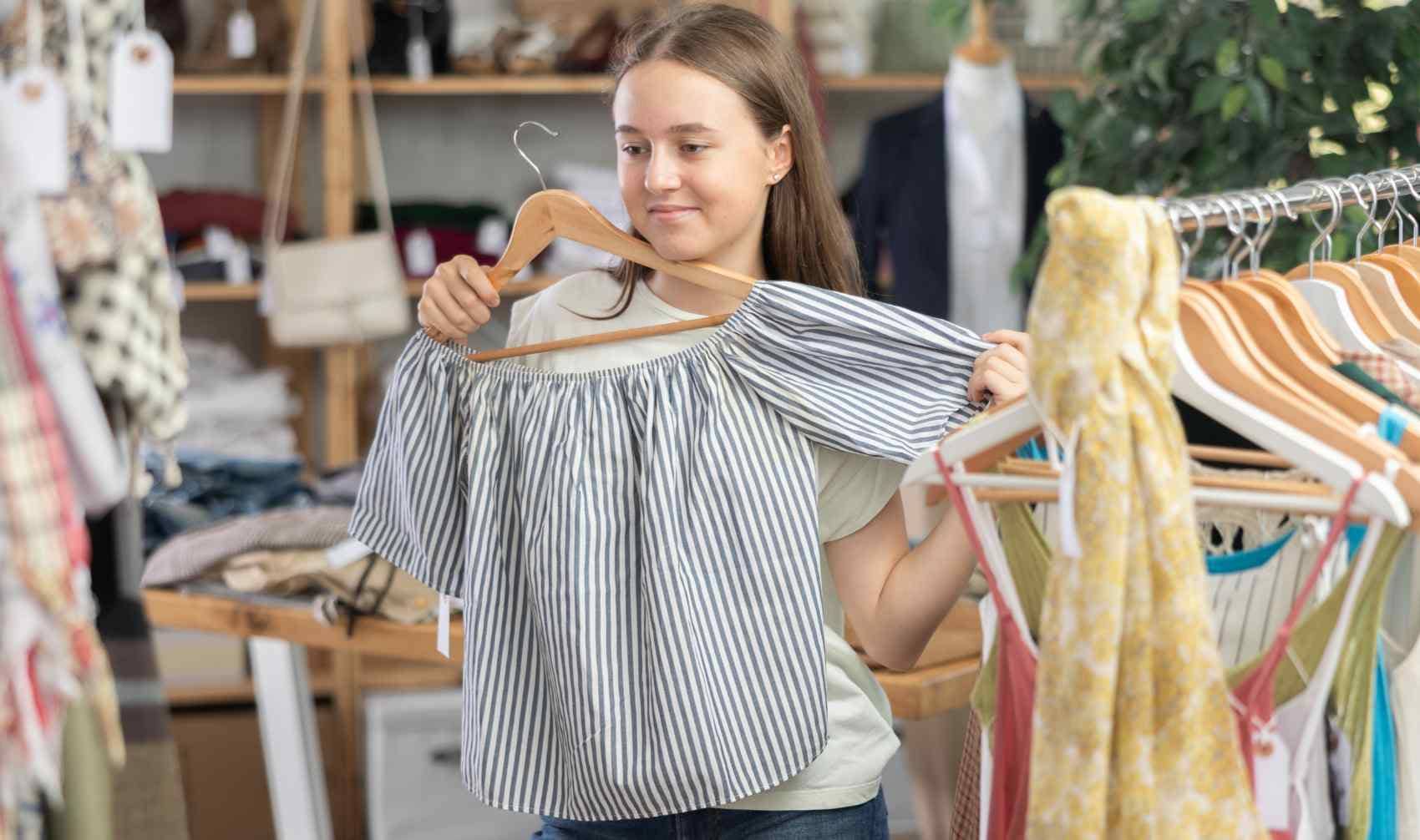 Teenager shopping for clothing.