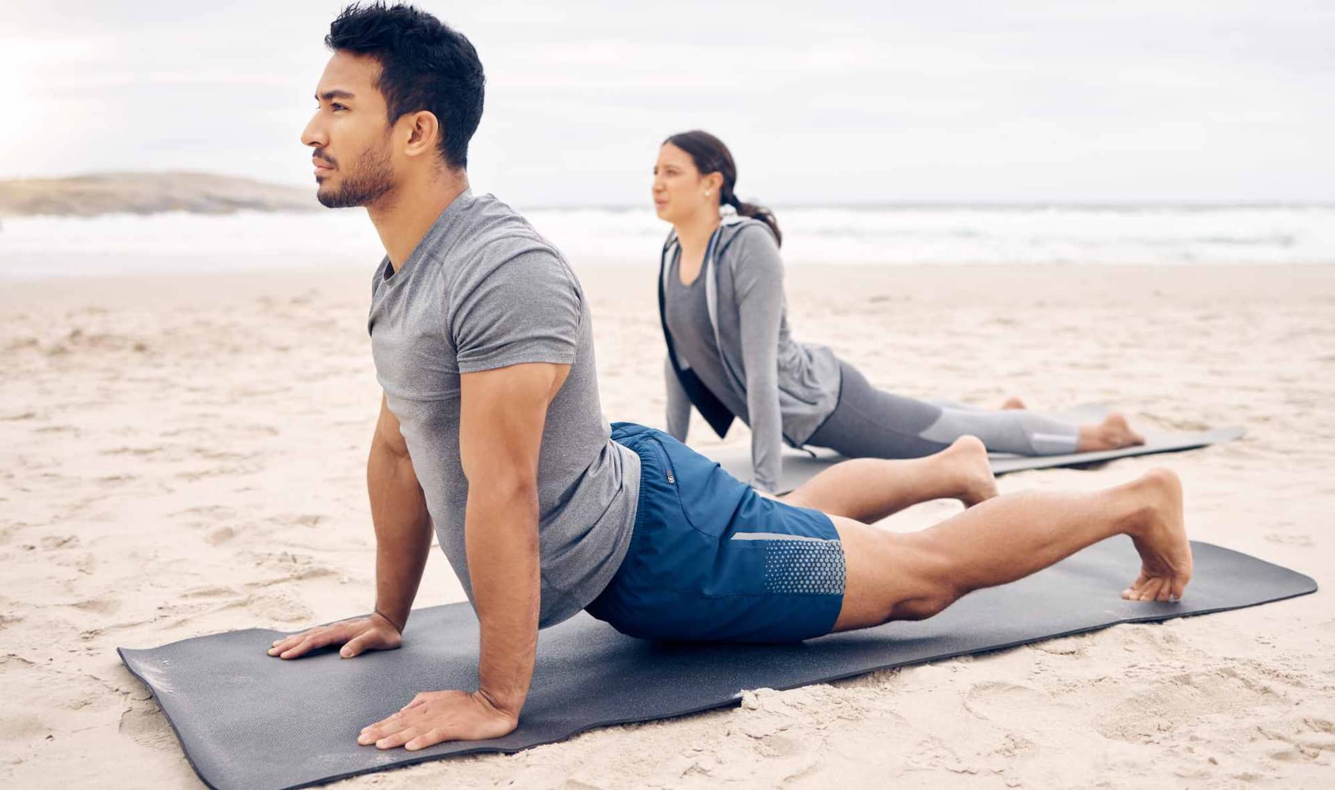 Couple doing the upward facing Tibetan rite.