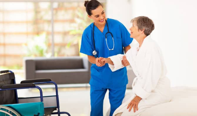 A nurse helps a patient