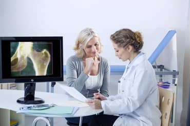 A doctor and patient looking at x-rays.