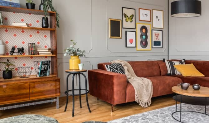 Eclectic living room with a rust-colored sofa.