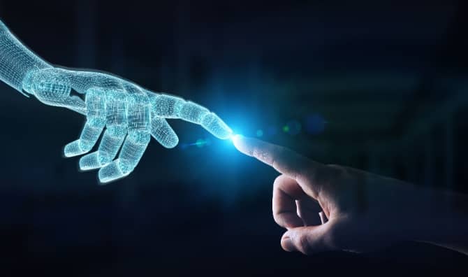 Wireframed robot hand making contact with human hand, depicting AI innovation.