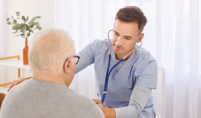 Young doctor examining an elderly patient.