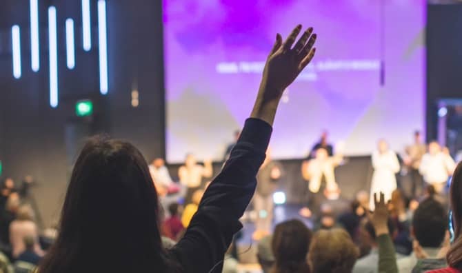 People raising their hands in praise.