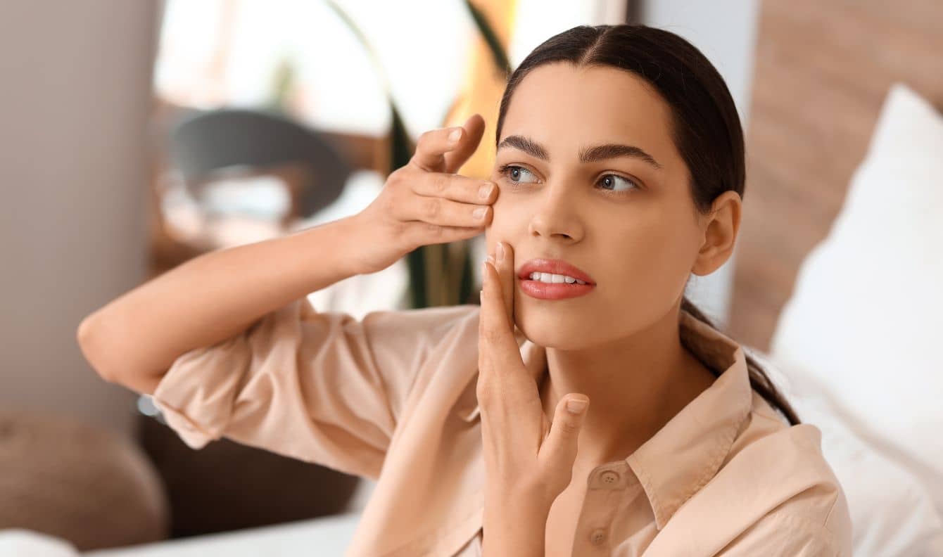 Woman doing face yoga.