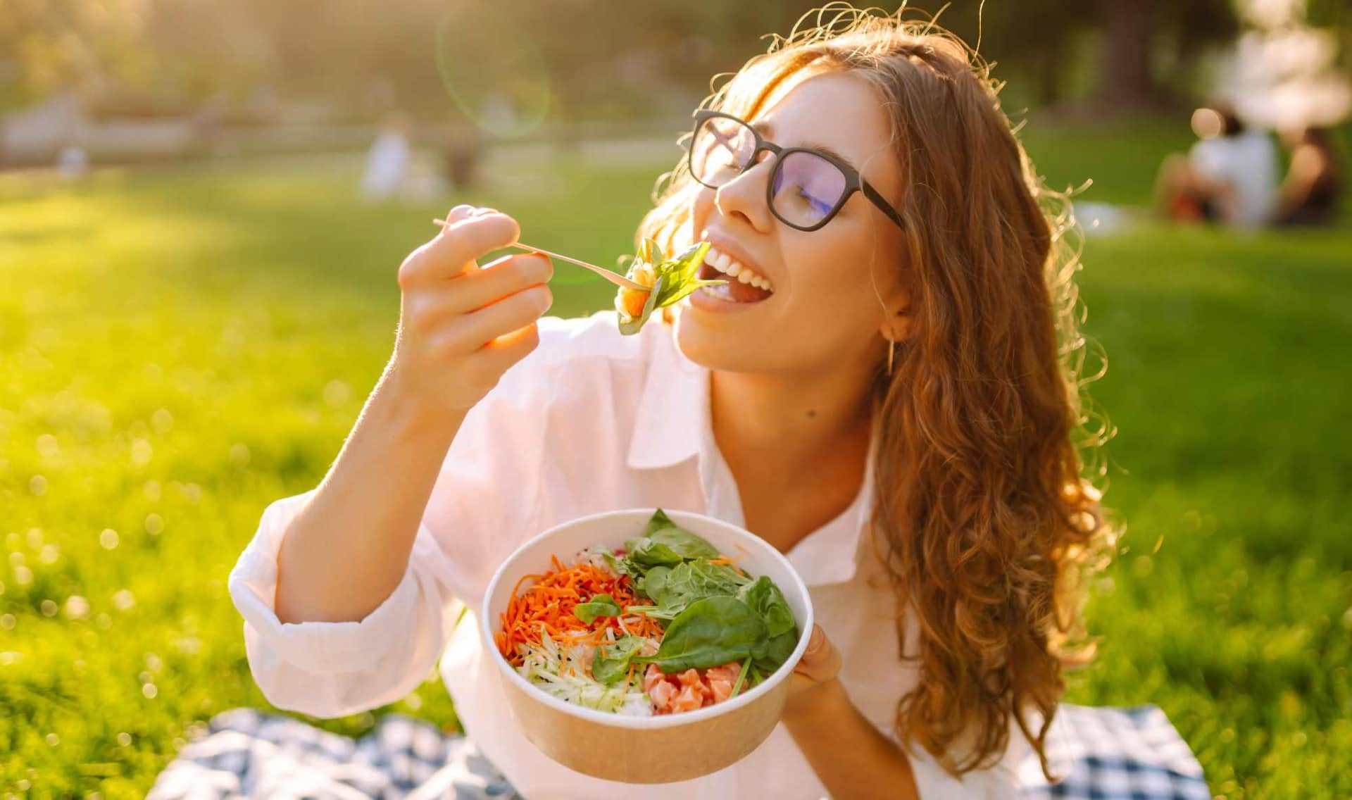 A young woman savoring her food.