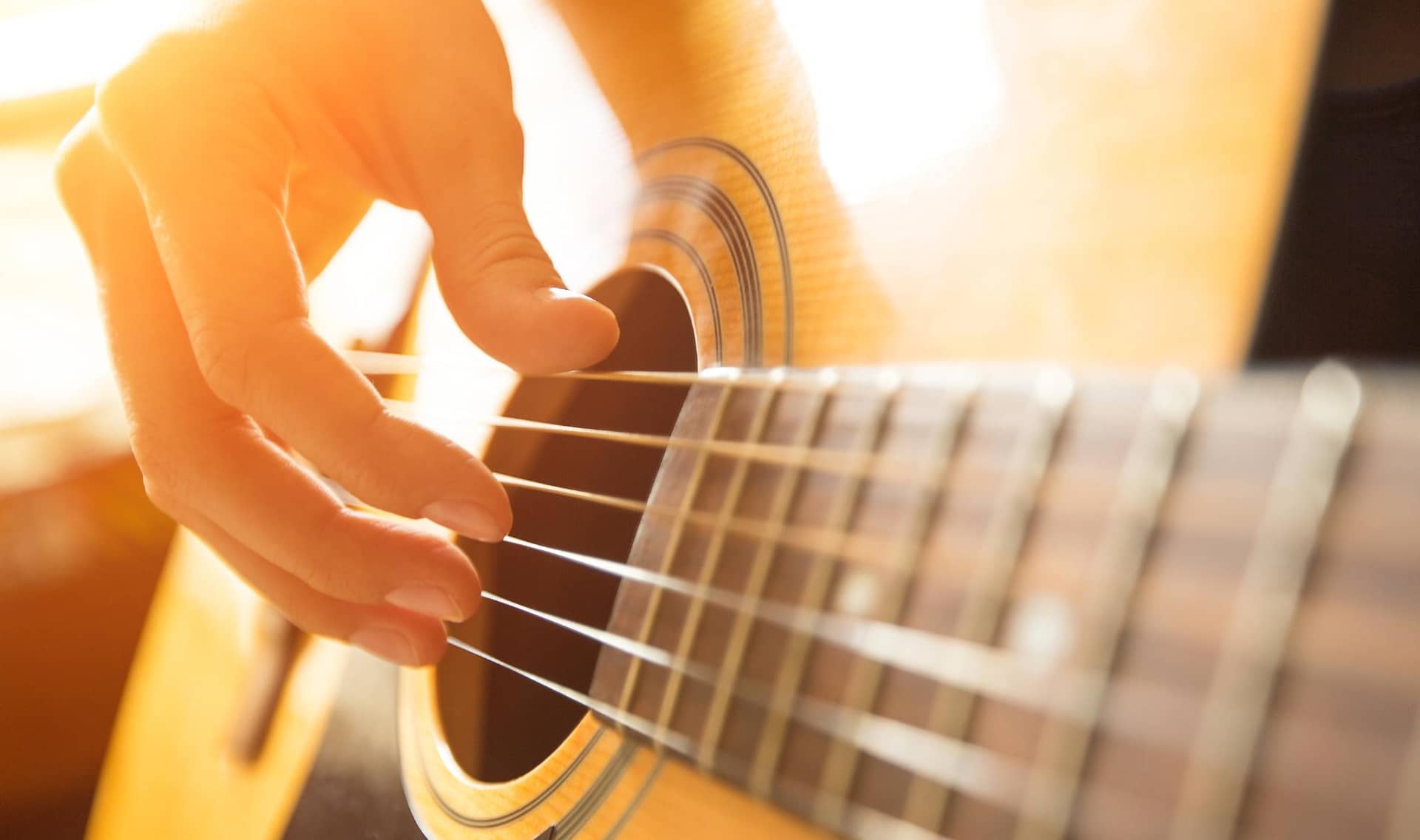 Woman playing a guitar.