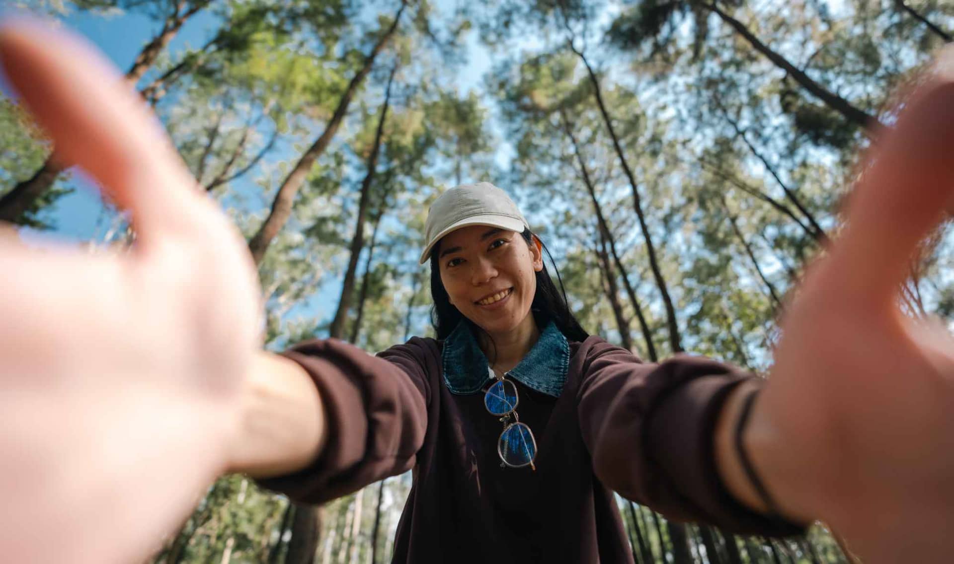 A woman relaxes in a forest.