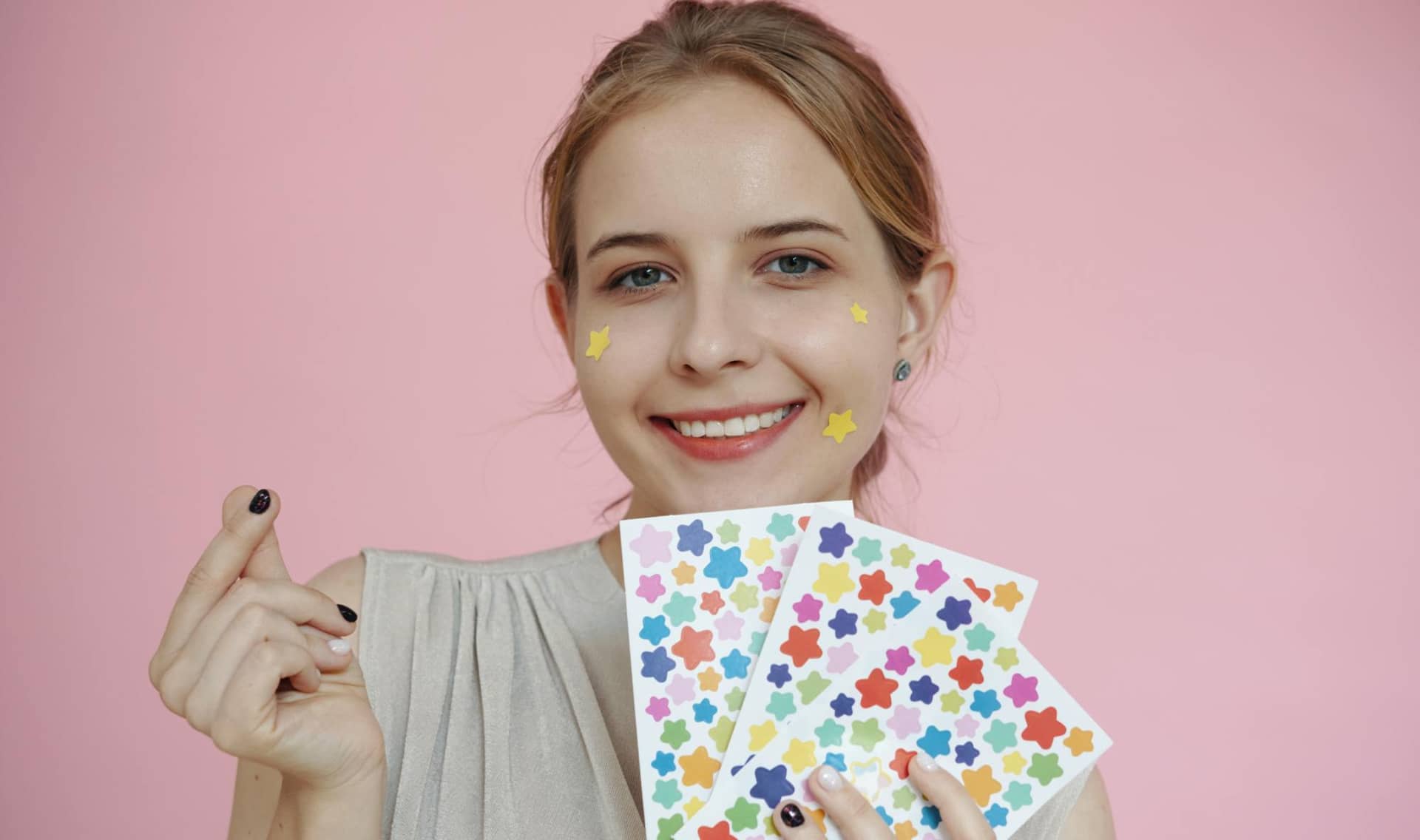 A Woman holding star stickers.