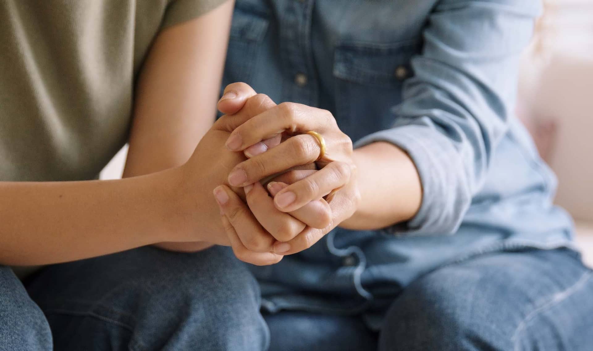 People hold hands.