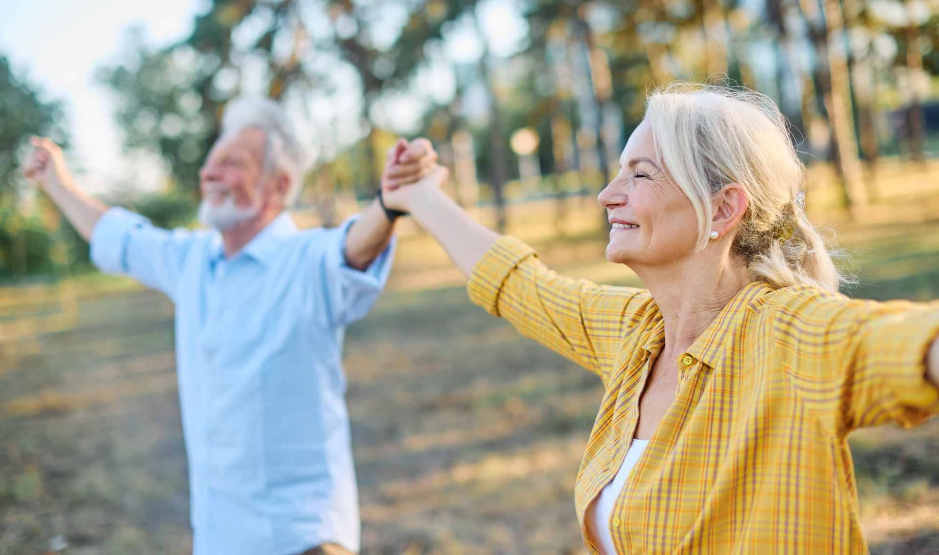 A happy active senior couple relaxing outdoors.