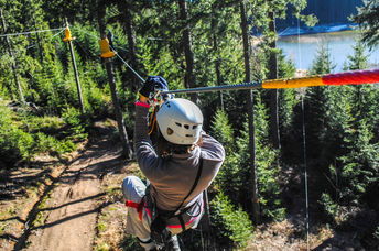 Woman sliding on a zip line in an adventure park (Shutterstock)