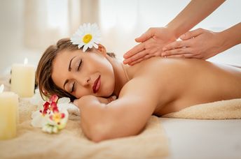 Woman enjoying during a back massage at a spa.