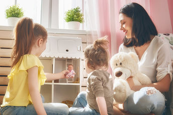 Girls holding lottie dolls