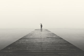 business man with umbrella looking at the horizon
