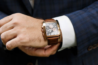 A closeup of designer watch on a businessman's hand