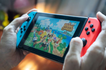 Man playing Animal Crossings on Nintendo Switch.