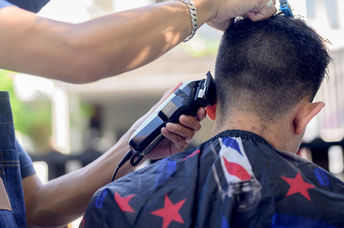Cutting hair outside.