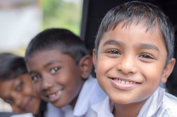 Happy, healthy Indian children smiling as they go to school.