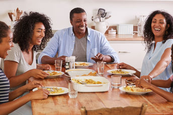 A family eating together promotes health benefits.