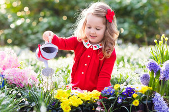 A child in a flower garden.