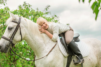 Girl getting pet therapy with a horse.