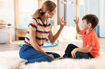 Mother using sign language with son.