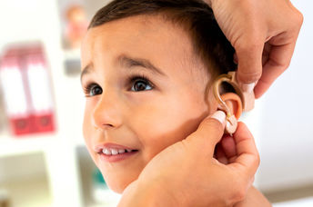 Boy being fitted for a hearing aid.